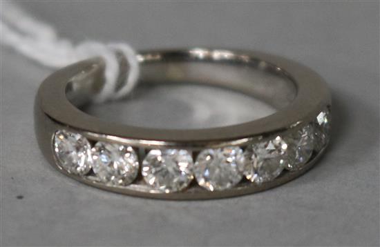 A modern 18ct white gold and seven stone diamond half hoop ring, size M.
